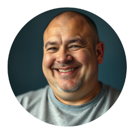 Chubby, mixed-race, balding male smiling, showcasing a joyful demeanor.